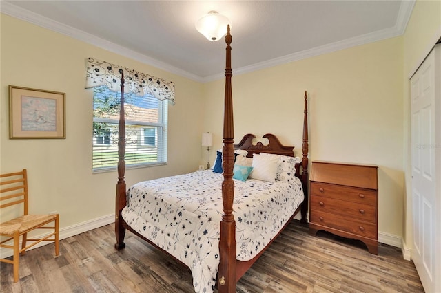 bedroom with hardwood / wood-style flooring, a closet, and crown molding