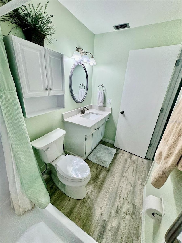 bathroom featuring hardwood / wood-style floors, toilet, and vanity