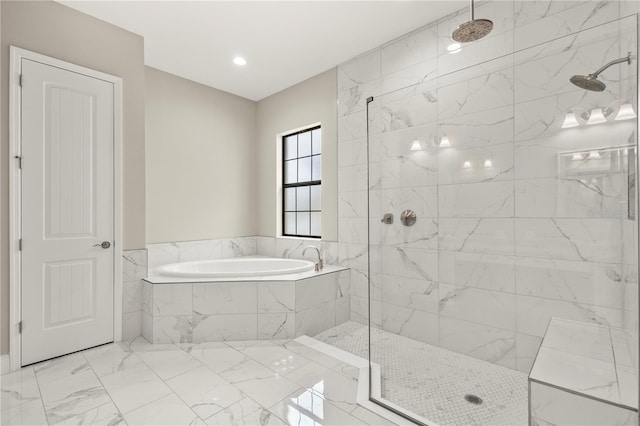 bathroom featuring shower with separate bathtub