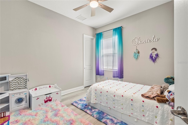 bedroom with ceiling fan and light hardwood / wood-style floors