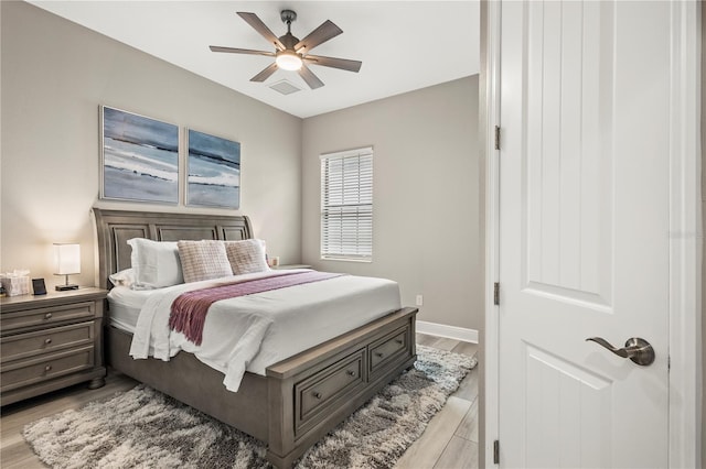 bedroom with ceiling fan and light hardwood / wood-style flooring