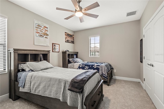 bedroom with light colored carpet and ceiling fan