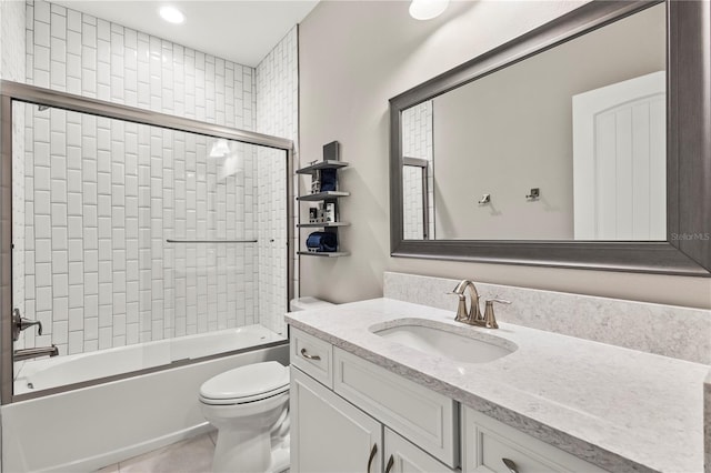 full bathroom featuring bath / shower combo with glass door, vanity, and toilet