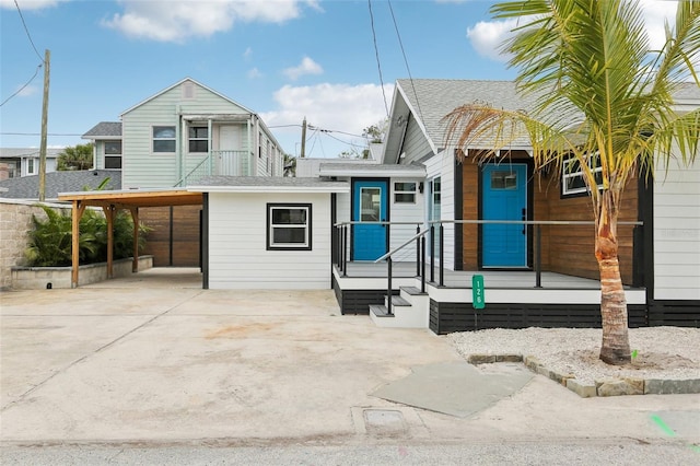 rear view of property with a carport