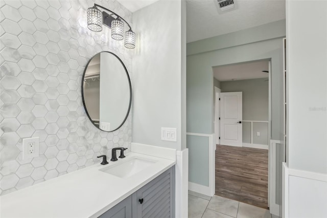 bathroom with tile walls, tile patterned floors, and vanity