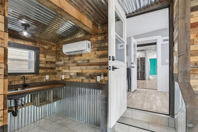 interior space with an AC wall unit and sink