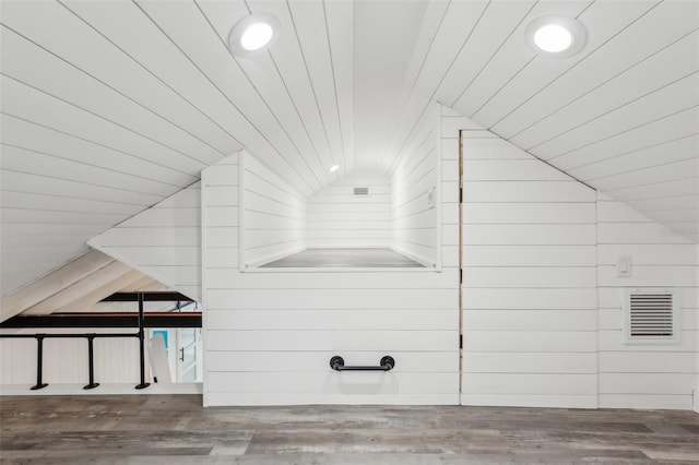 interior details with hardwood / wood-style flooring and wooden walls