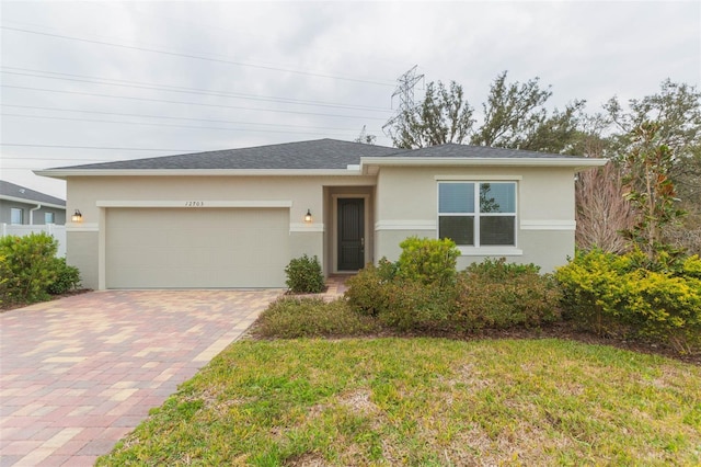 view of front facade featuring a garage and a front lawn