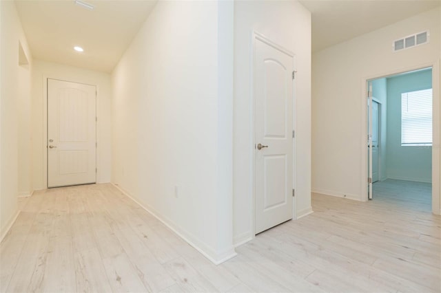 hallway with light wood-type flooring