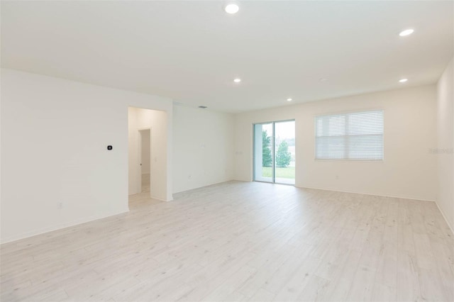 empty room with light hardwood / wood-style flooring