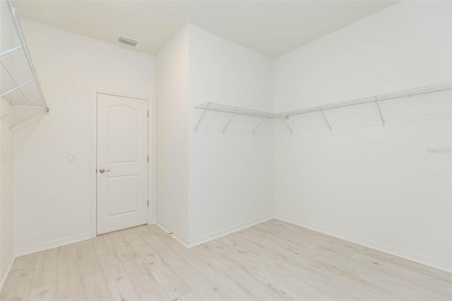 spacious closet with light hardwood / wood-style floors