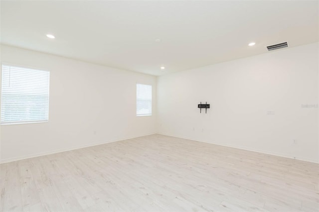 spare room with light hardwood / wood-style flooring