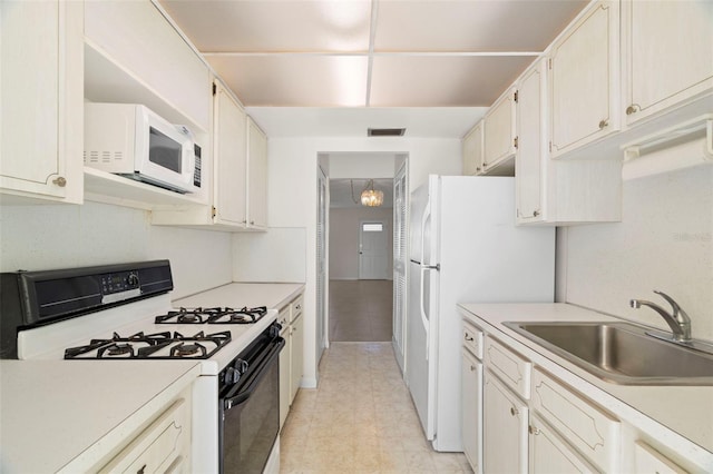 kitchen featuring sink and white appliances