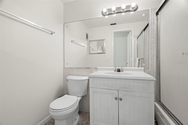 full bathroom with vanity, shower / bath combination with glass door, and toilet