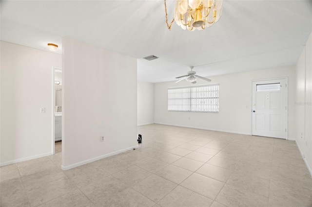 unfurnished room with ceiling fan with notable chandelier and light tile patterned floors