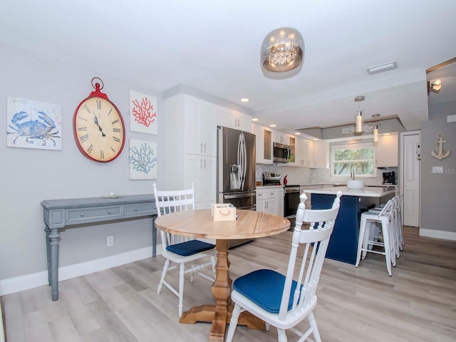 dining area with light hardwood / wood-style floors