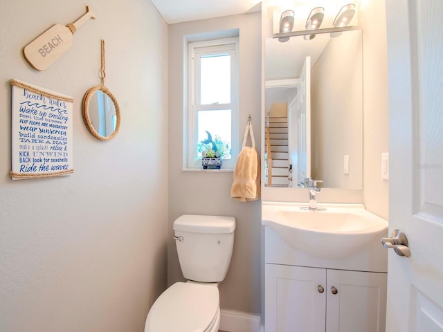 bathroom featuring toilet and vanity