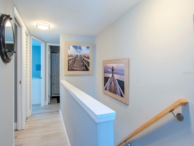 corridor with light hardwood / wood-style floors