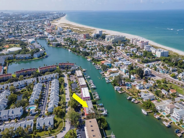 birds eye view of property with a water view and a beach view