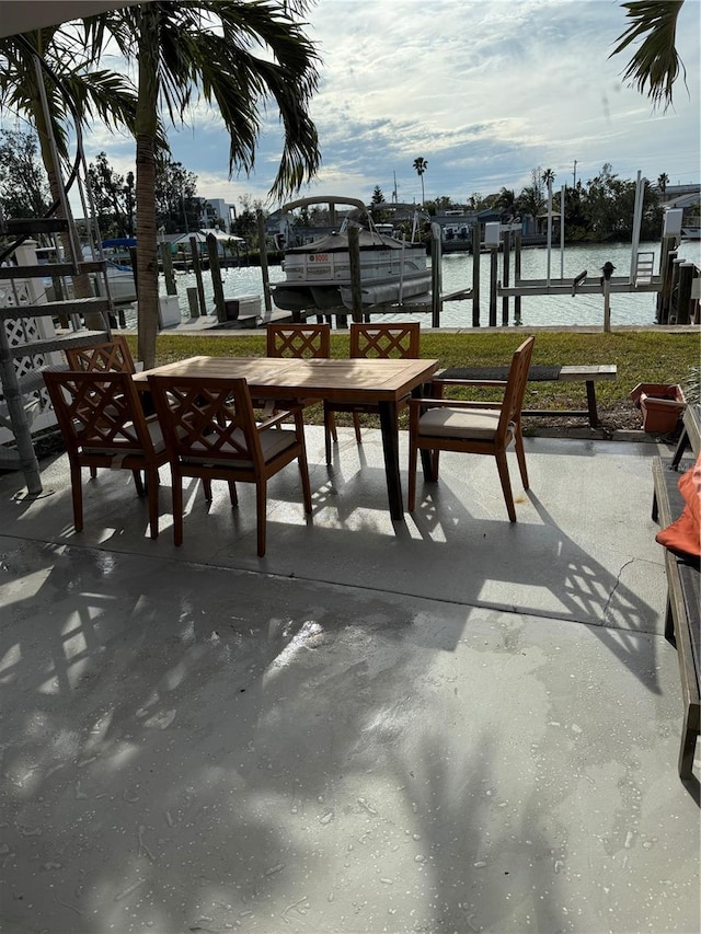 view of patio with a water view and a boat dock