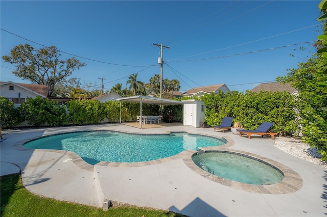 view of pool featuring an in ground hot tub and a patio area