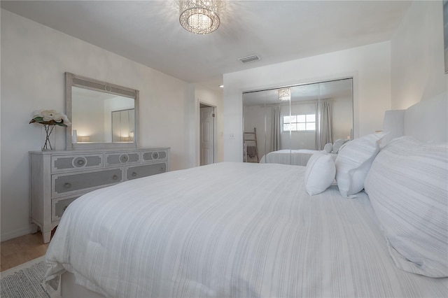 bedroom with hardwood / wood-style floors and a closet