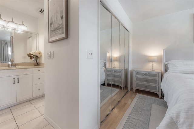 bedroom featuring sink, a closet, and ensuite bathroom