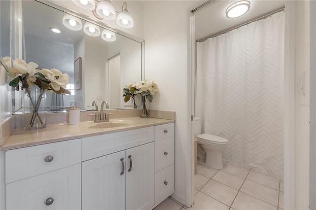 bathroom with vanity, tile patterned floors, and toilet