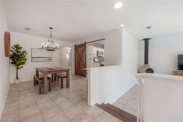 tiled dining room featuring a barn door