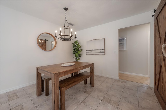 tiled dining space with an inviting chandelier and a barn door