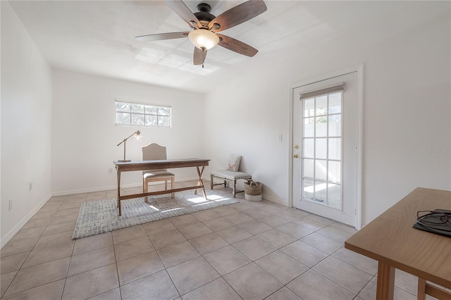 home office with light tile patterned flooring and ceiling fan