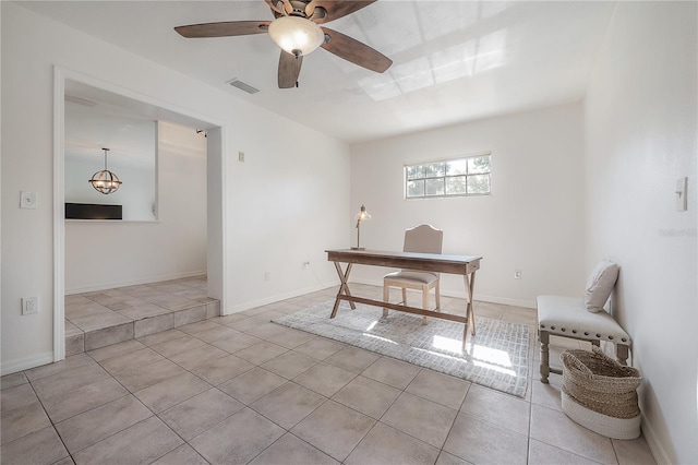 tiled office space featuring ceiling fan