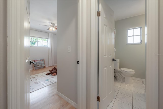 bathroom featuring wood-type flooring, ceiling fan, and toilet