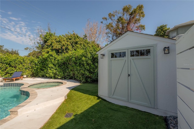 view of outdoor structure with a yard and a pool with hot tub