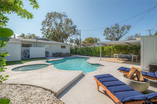 view of swimming pool featuring a patio area and an in ground hot tub