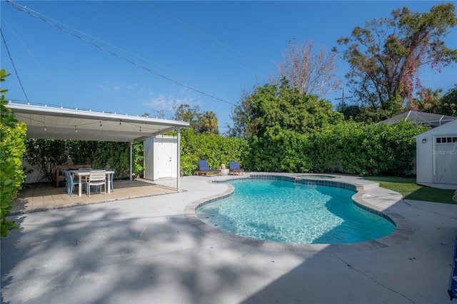 view of swimming pool featuring an in ground hot tub and a patio