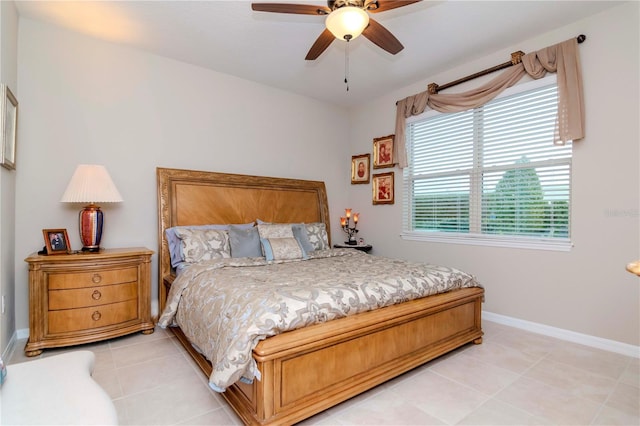 bedroom featuring light tile patterned floors, ceiling fan, and baseboards