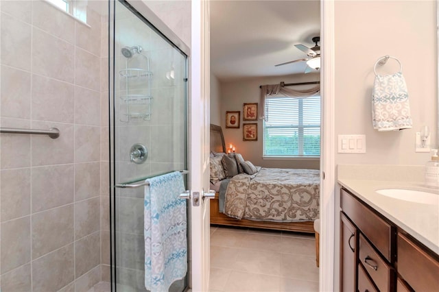 ensuite bathroom featuring tile patterned flooring, ceiling fan, tiled shower, and ensuite bathroom