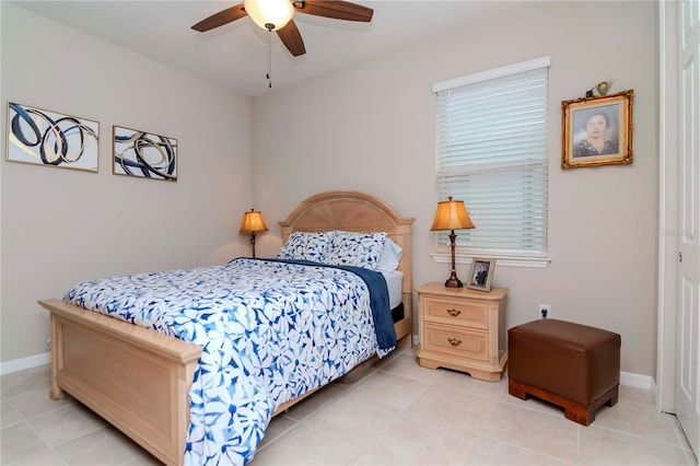 bedroom featuring light tile patterned floors, ceiling fan, and baseboards