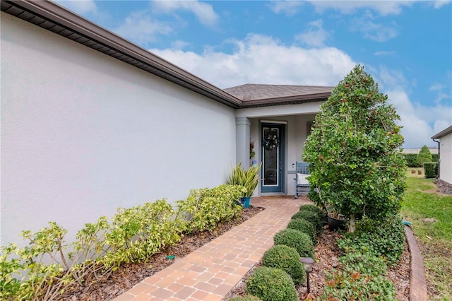 property entrance featuring stucco siding