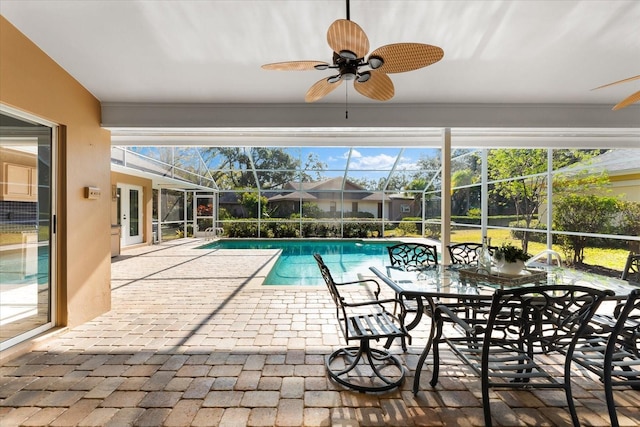 outdoor pool featuring a lanai, a patio area, and ceiling fan