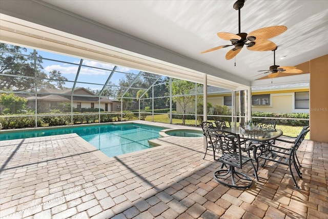 view of pool with a lanai, a pool with connected hot tub, a ceiling fan, and a patio