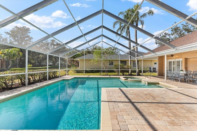 view of swimming pool with a pool with connected hot tub, a patio area, and a lanai