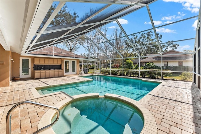 view of swimming pool with a pool with connected hot tub, french doors, glass enclosure, and a patio