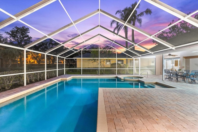 view of swimming pool with a lanai, a patio area, and a pool with connected hot tub