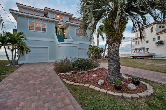 mediterranean / spanish-style house with a garage