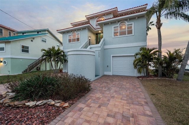 mediterranean / spanish-style home featuring a garage