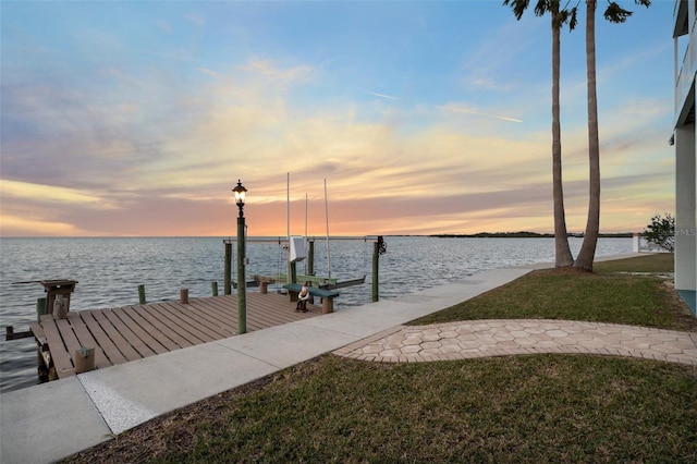 dock area featuring a water view and a yard