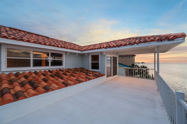 patio terrace at dusk with a water view