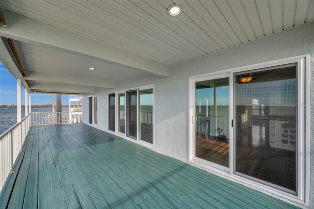 wooden deck featuring a water view